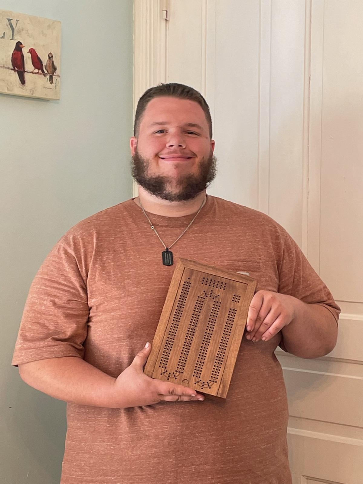 The happy customer holding his new cribbage box