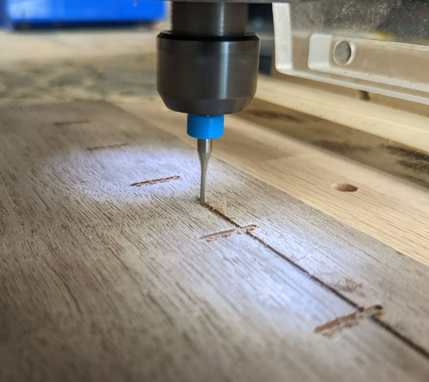 CNC router cutting grooves in walnut top